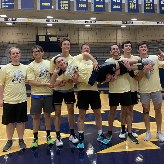 Men's volleyball team posing for photo
