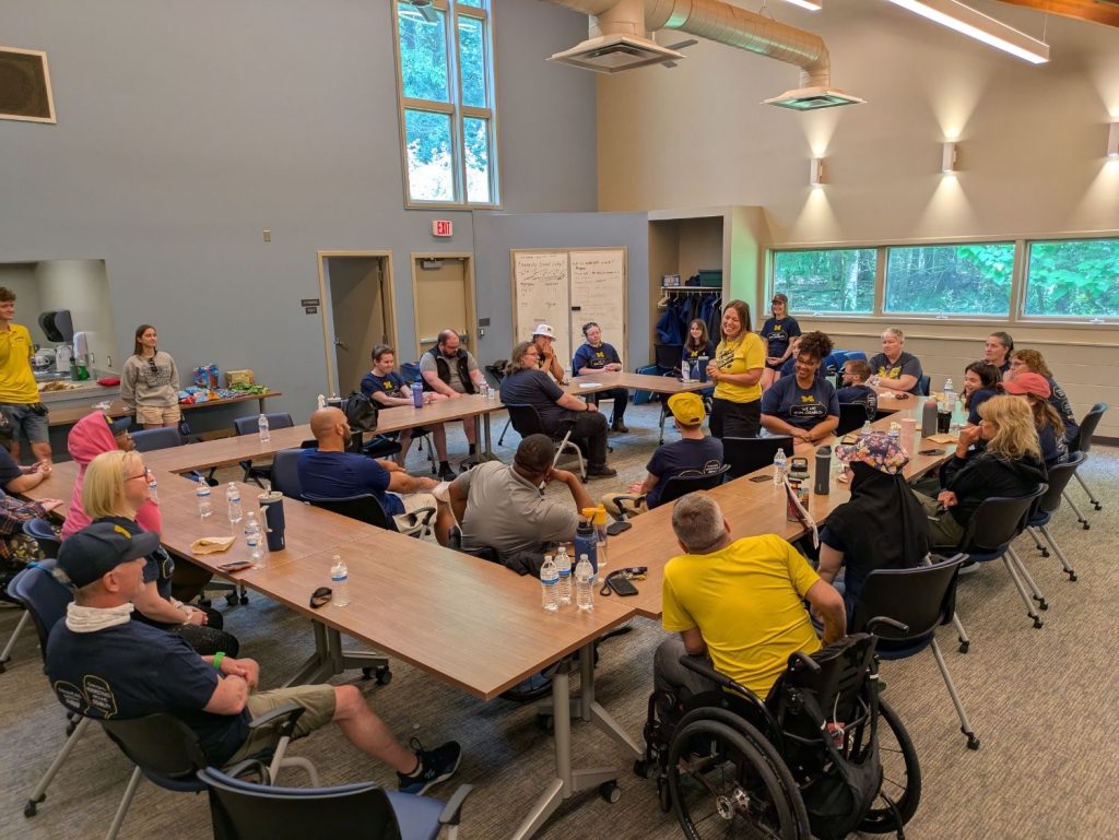 Large group having discussion in a bright meeting room.